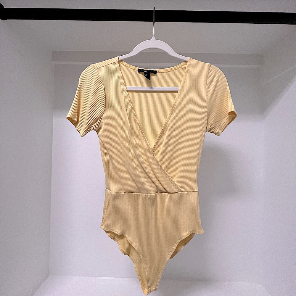 Brighten up your wardrobe with this vibrant Chic Yellow Bodysuit - Forever 21